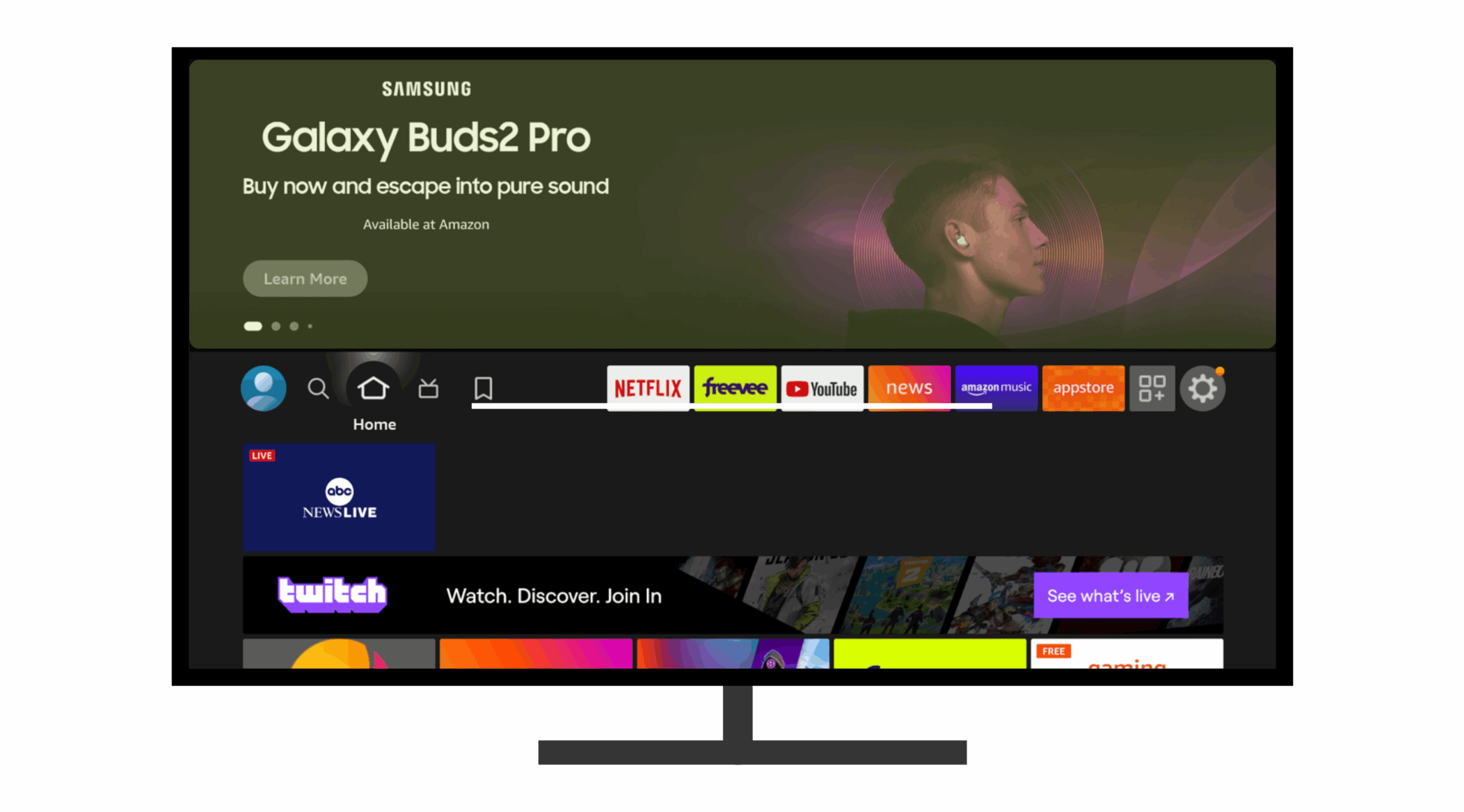 Screenshot of a Fire TV home screen interface showing a fullscreen top banner ad for the Samsung Galaxy Buds2 Pro. The ad features a young man wearing the earbuds, with the tagline “Buy now and escape into pure sound” and a “Learn More” button. The ad notes availability on Amazon. Below the banner is the Fire TV navigation menu, featuring icons for Netflix, Freevee, YouTube, News, Amazon Music, and the Appstore. Other navigation icons on the left include user profile, search, home, live TV, and bookmarks. The main screen area below the ad showcases live content thumbnails such as ABC News Live and Twitch, with various entertainment tiles partially visible at the bottom.